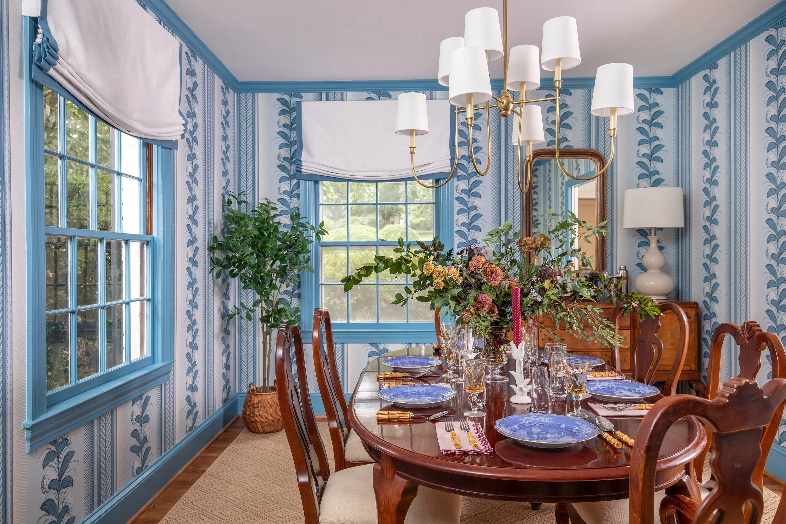 Warm, layered living space with colorful classic furnishings by a Raleigh interior designer